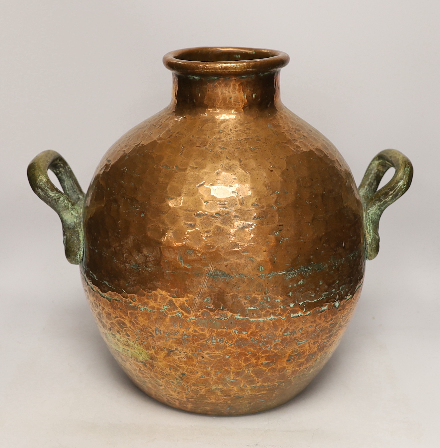 A copper vessel with double brass handles, 39cm high